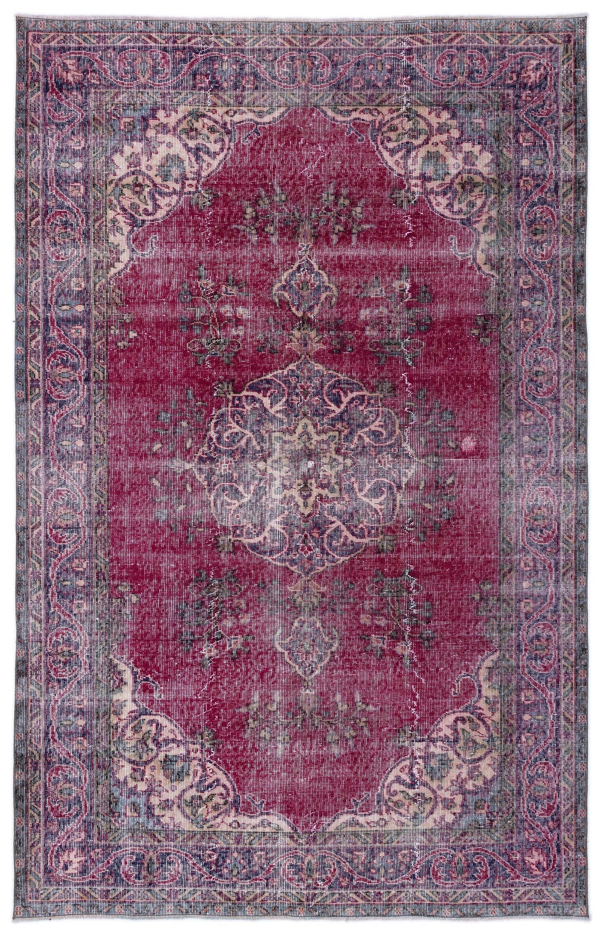 Distressed magenta and navy blue traditional rug with a central floral medallion and ornate border.