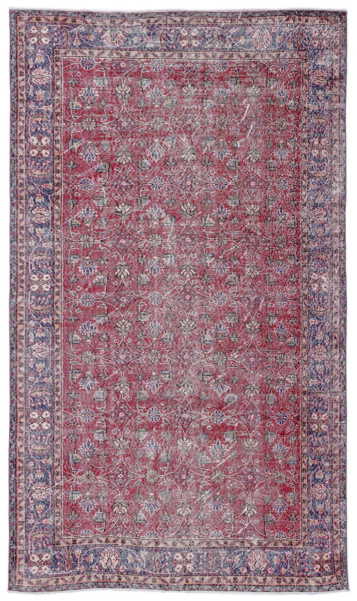 Distressed red and blue traditional rug with a floral medallion pattern and a wide decorative border.