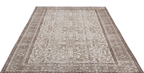Load image 1 in gallery view. Taupe and cream vintage-style rug with a distressed floral medallion pattern and a wide decorative border.