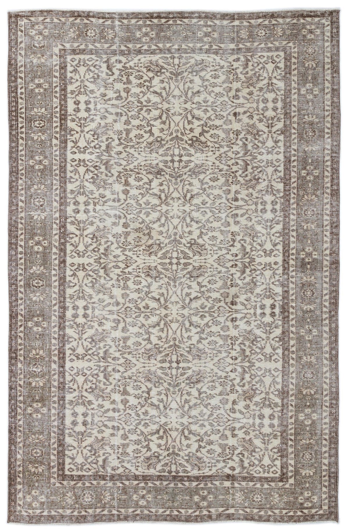 Taupe and cream vintage-style rug with a distressed floral medallion pattern and a wide decorative border.