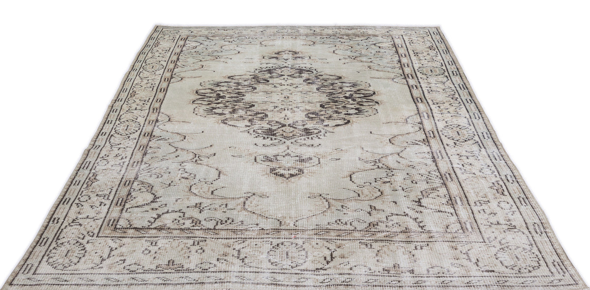Beige and brown distressed vintage-style rug with a central medallion and ornate border pattern on a white background.