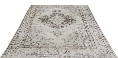 Load image 1 in gallery view. Beige and brown distressed vintage-style rug with a central medallion and ornate border pattern on a white background.