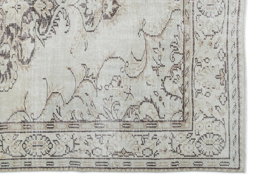 Load image 1 in gallery view. Beige and cream rug with a distressed, faded traditional floral medallion pattern and a detailed geometric border.