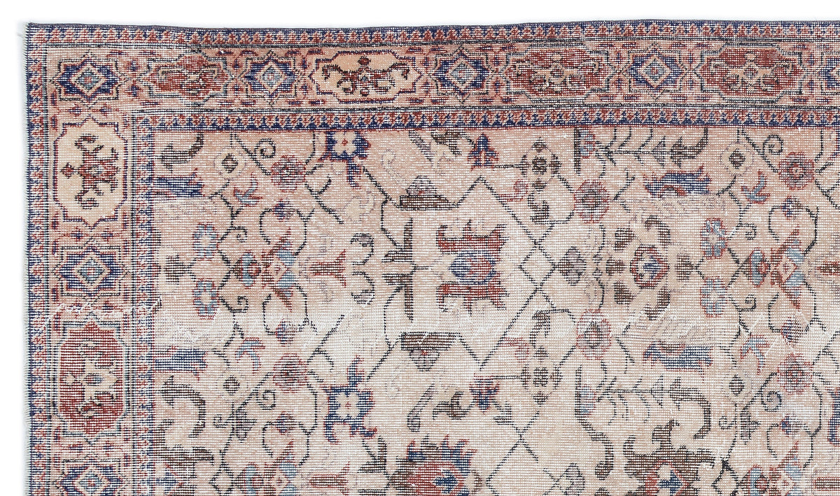 Beige, red, and blue traditional Persian-style rug with a distressed floral and geometric border and center pattern.