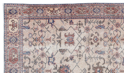 Load image 1 in gallery view. Beige, red, and blue traditional Persian-style rug with a distressed floral and geometric border and center pattern.