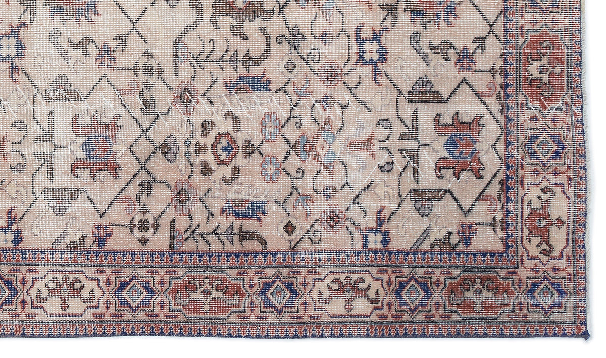 Beige traditional rug with a distressed geometric lattice pattern, featuring red and blue floral motifs and a border.