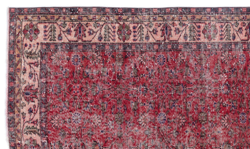 Load image 1 in gallery view. Distressed red and pink traditional rug with a floral medallion pattern and a dark charcoal border.