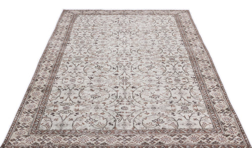 Load image 1 in gallery view. Beige and brown vintage-style rug with a distressed floral vine pattern and a decorative border.