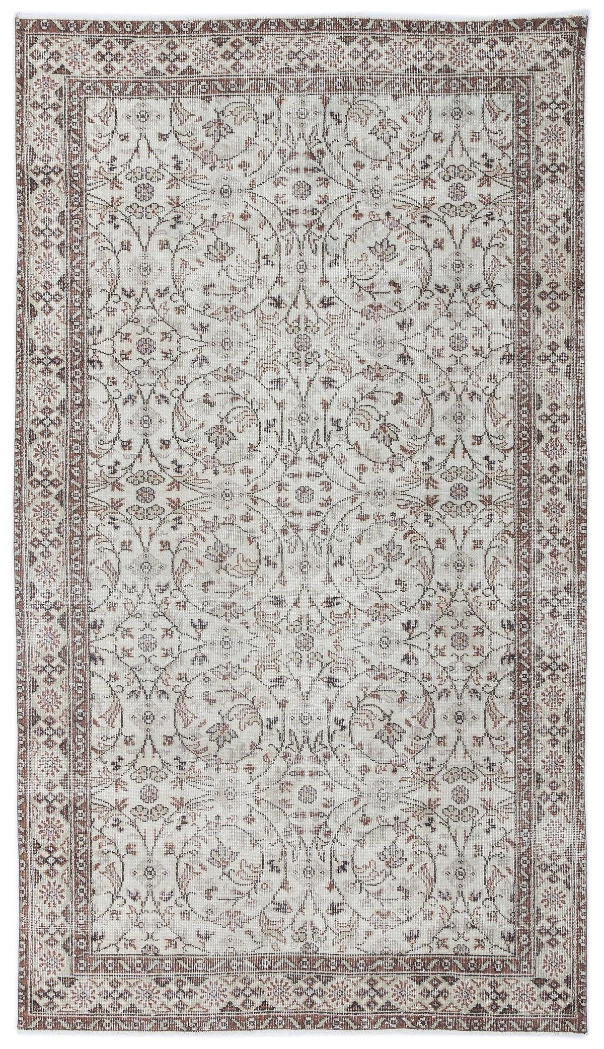 Cream and brown traditional rug with a distressed floral medallion pattern and a detailed geometric border.