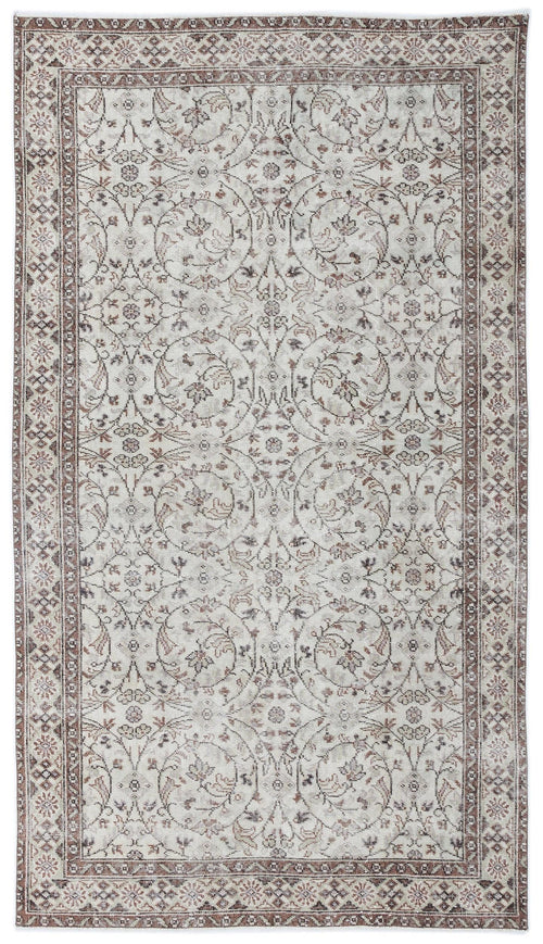 Load image 1 in gallery view. Cream and brown traditional rug with a distressed floral medallion pattern and a detailed geometric border.