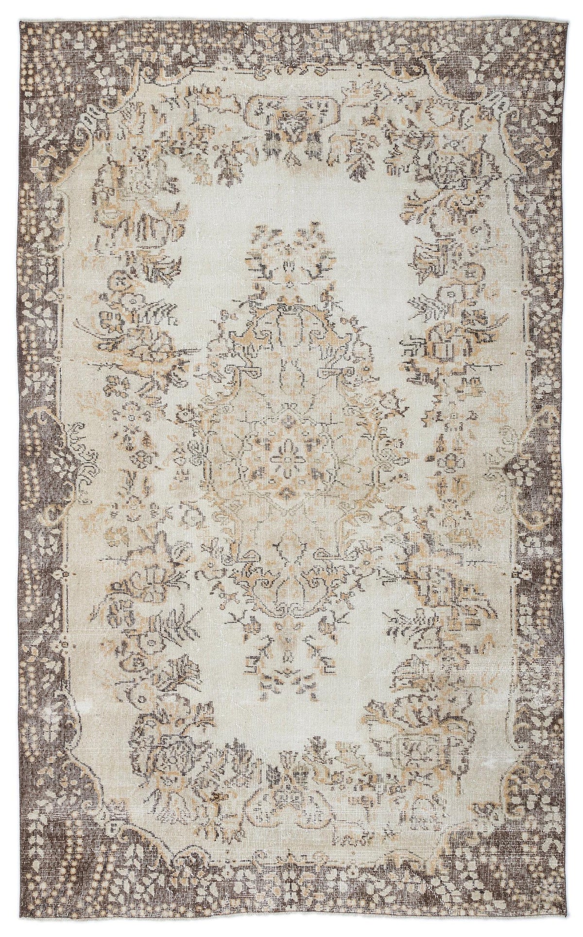 Cream and brown vintage-style rug with a central floral medallion and a distressed, ornate border.