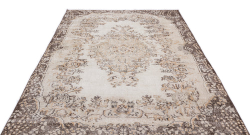 Load image 1 in gallery view. Cream and brown distressed rug with a traditional central medallion and ornate border on a white background.