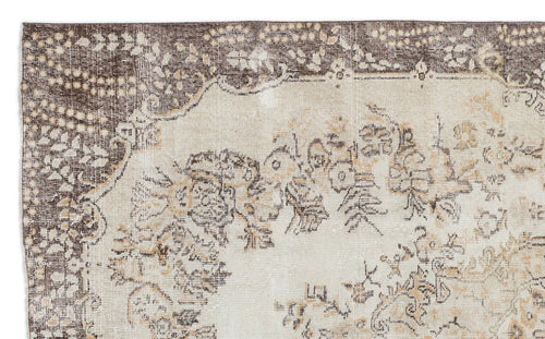 Load image 1 in gallery view. Distressed beige and brown rug with a faded floral medallion pattern and a dark decorative border.