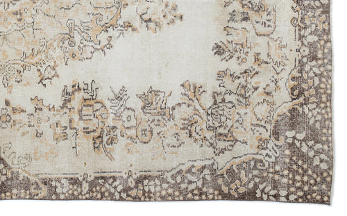 Load image 1 in gallery view. Cream and brown distressed rug with a faded floral medallion pattern and a wide, intricate border.