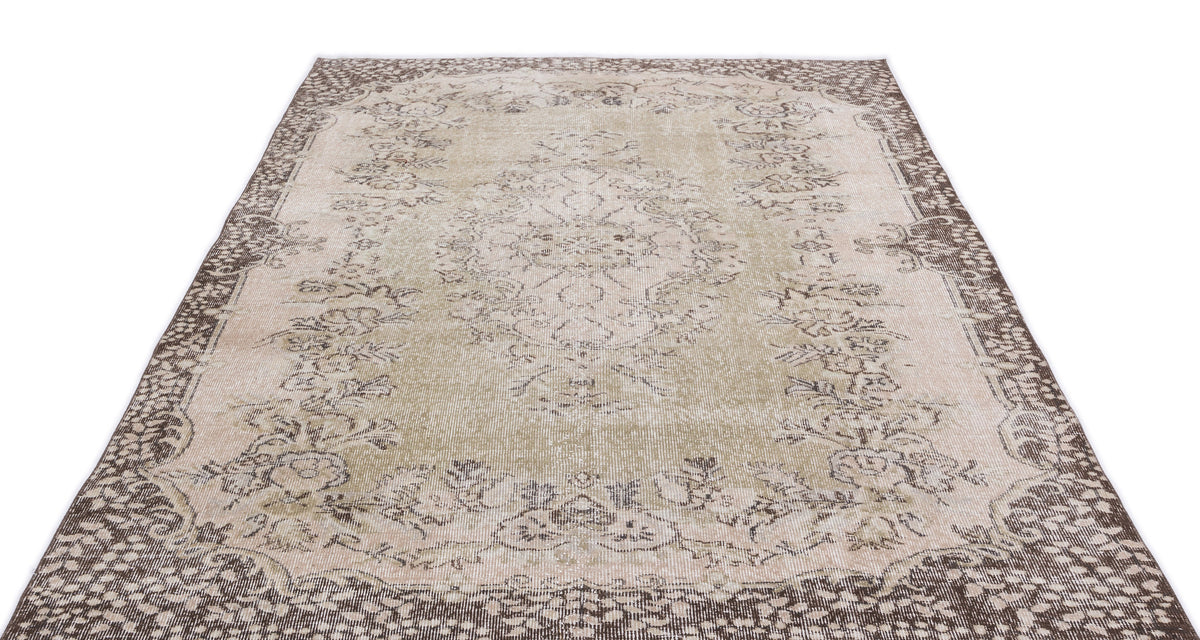 Beige and brown vintage-style rug with a central floral medallion and ornate border on a white background.