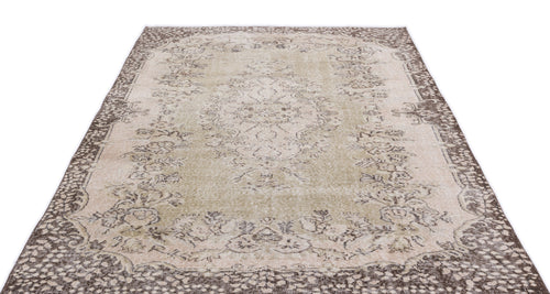 Load image 1 in gallery view. Beige and brown vintage-style rug with a central floral medallion and ornate border on a white background.
