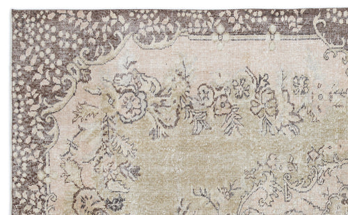 Load image 1 in gallery view. Brown and beige vintage-style rug with a distressed floral medallion pattern and a detailed border.