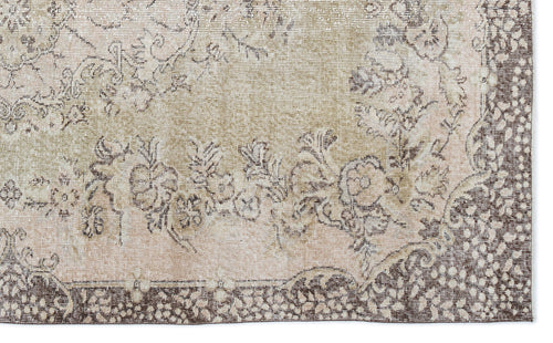 Load image 1 in gallery view. Beige and brown distressed rug with a traditional floral medallion pattern and a detailed border.