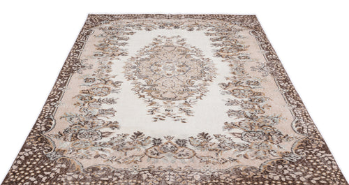 Load image 1 in gallery view. Cream and brown traditional rug with a central floral medallion and ornate border on a white background.