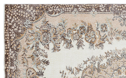 Load image 1 in gallery view. Distressed beige, brown, and light blue rug with a traditional floral medallion pattern and ornate border.