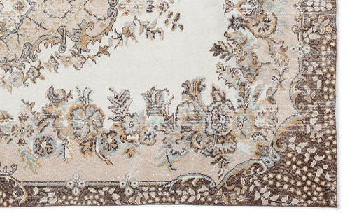 Load image 1 in gallery view. Cream, brown, and sage green rug with a distressed floral medallion pattern and a dark brown decorative border.