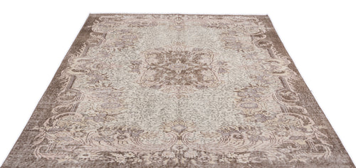 Load image 1 in gallery view. Brown and cream traditional rug with a distressed floral medallion pattern on a white background.
