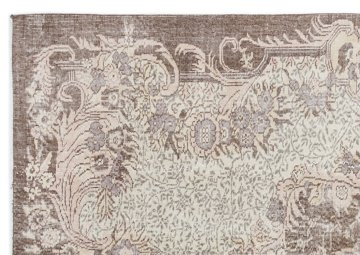 Brown and cream vintage-style rug with a distressed floral medallion pattern on a white background.