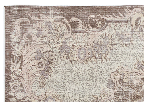 Load image 1 in gallery view. Brown and cream vintage-style rug with a distressed floral medallion pattern on a white background.