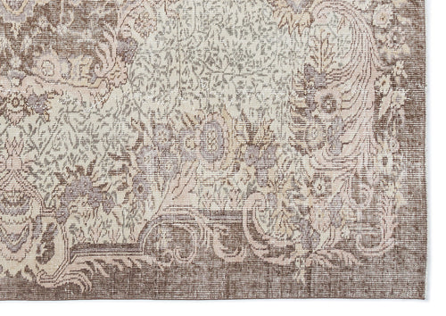 Load image 1 in gallery view. Brown and cream traditional rug with a distressed, faded floral medallion pattern.