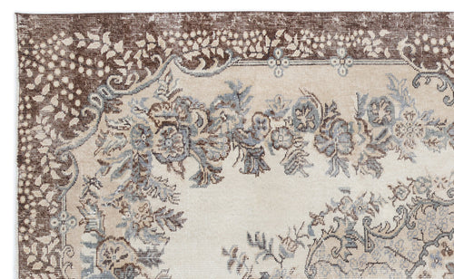 Load image 1 in gallery view. Beige, brown, and slate blue traditional rug with a floral medallion pattern and a wide decorative border.