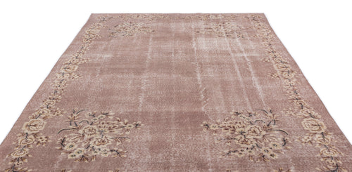Load image 1 in gallery view. Dusty rose vintage-style rug with a distressed finish and a cream floral border on a white background.