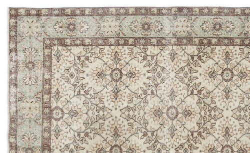 Load image 1 in gallery view. Beige, brown, and sage green traditional rug with a distressed floral medallion pattern and a decorative border.