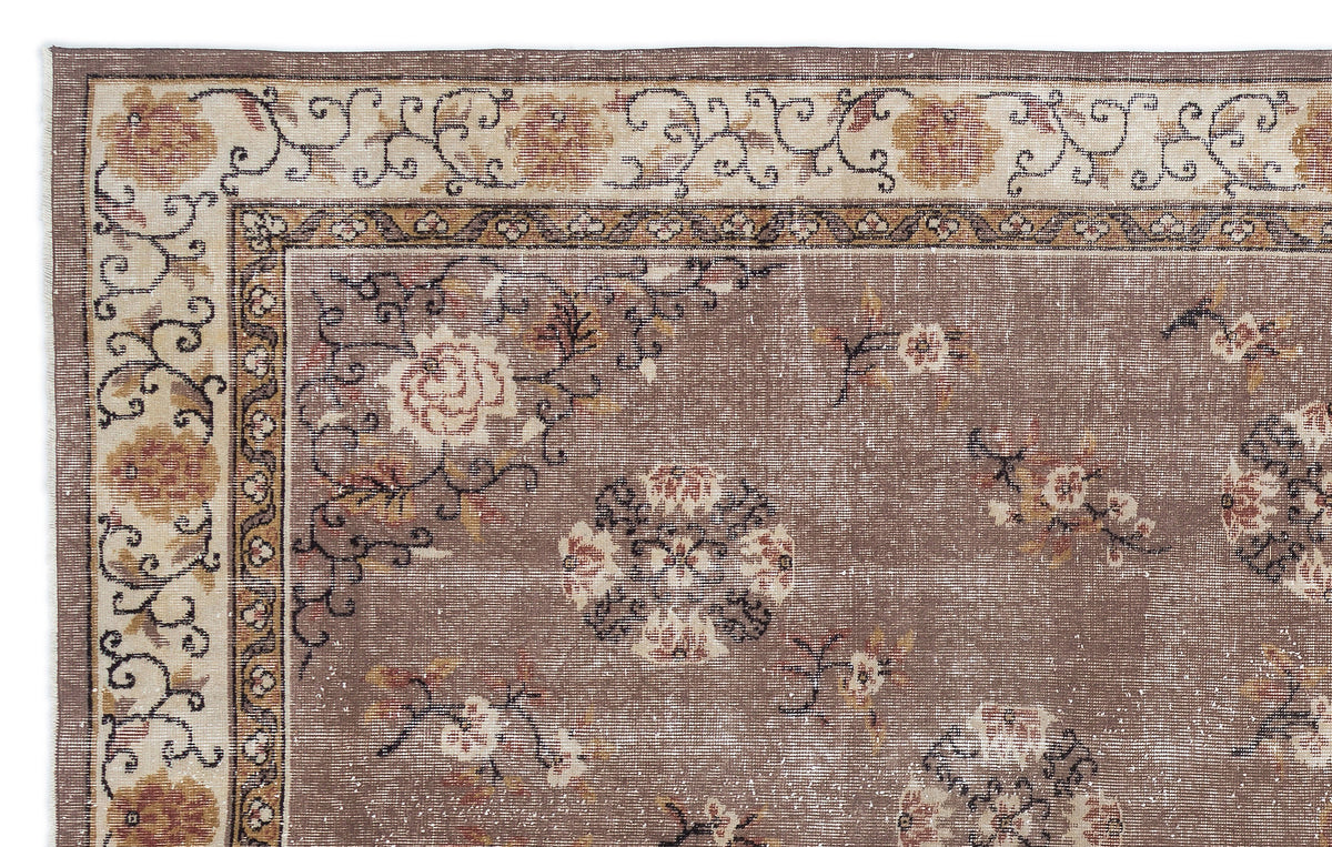 Brown and cream traditional rug with a distressed floral medallion pattern and ornate border.