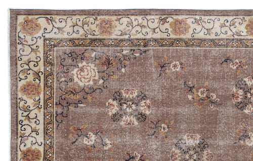 Load image 1 in gallery view. Brown and cream traditional rug with a distressed floral medallion pattern and ornate border.