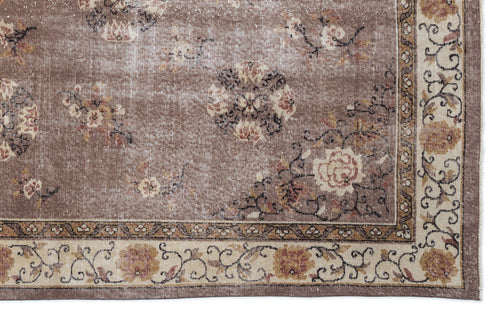 Load image 1 in gallery view. Taupe distressed rug with a faded floral medallion pattern and a decorative cream and brown border.