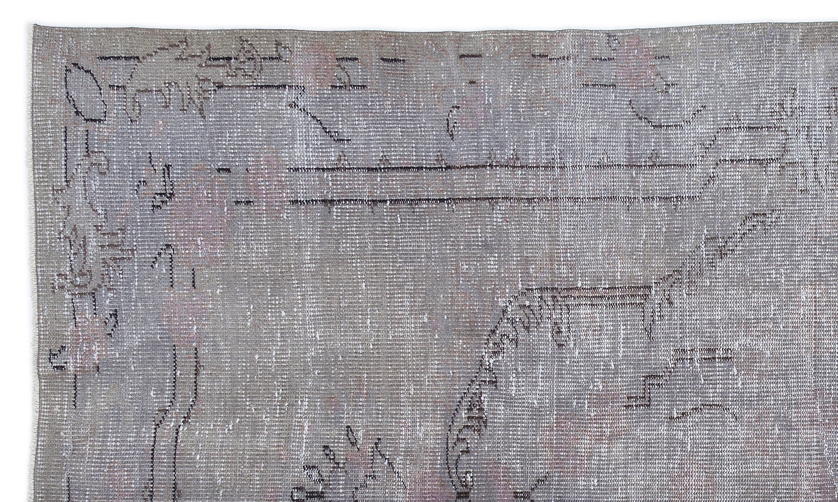 Grey and taupe distressed rug with a faded, abstract linear pattern on a white background.