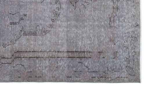 Load image 1 in gallery view. Grey and taupe distressed rug with a faded traditional medallion pattern and a visible fringe edge.