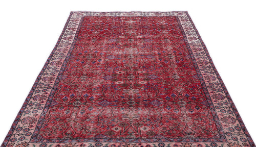 Load image 1 in gallery view. Distressed red Persian-style rug with a floral medallion pattern and a wide, intricate border on a white background.