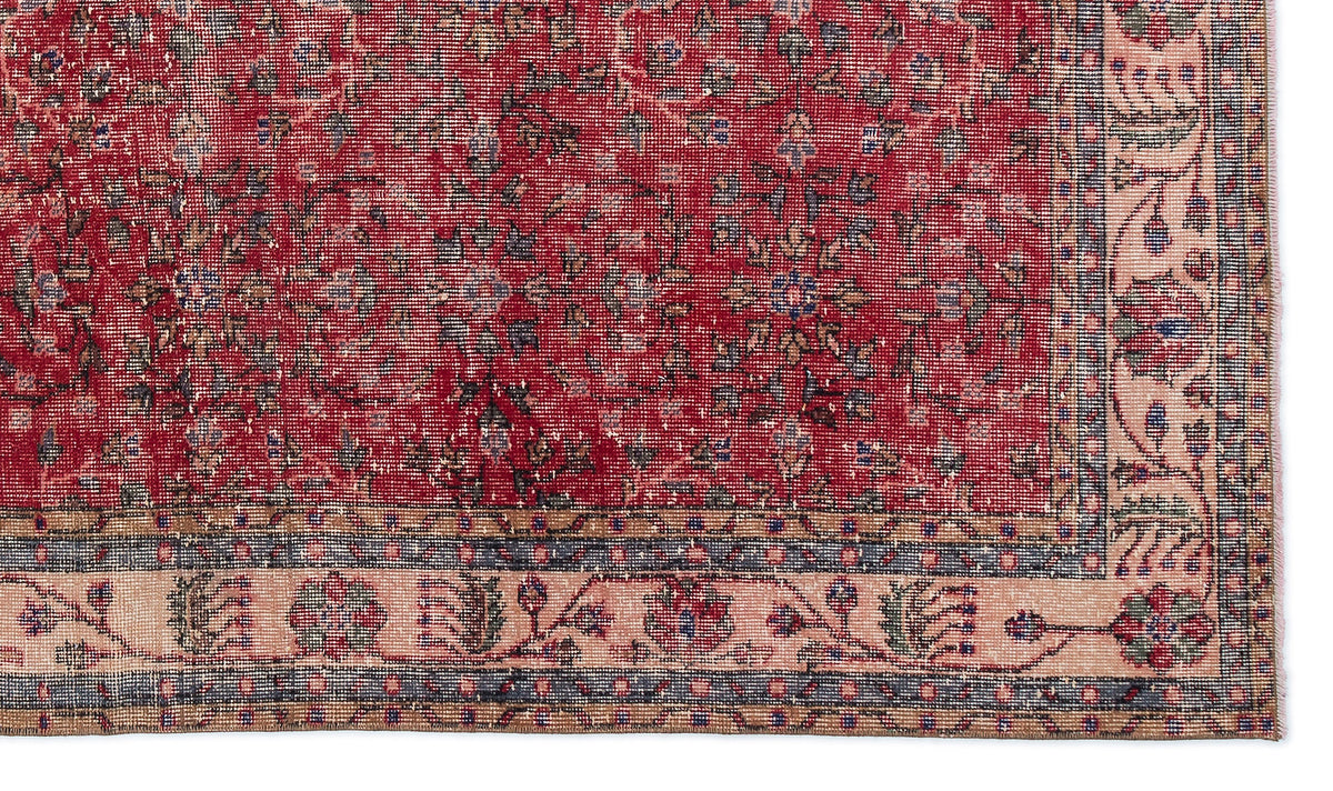 Red traditional rug with a distressed floral pattern and a beige border featuring intricate botanical motifs.