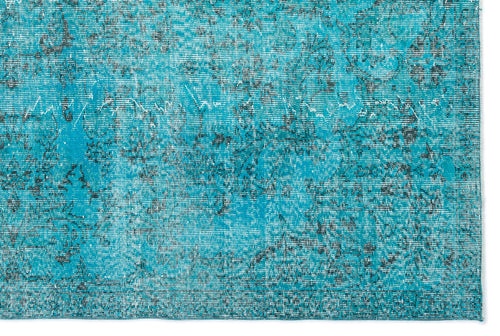 Load image 1 in gallery view. Turquoise and black distressed rug with a faded traditional floral pattern.