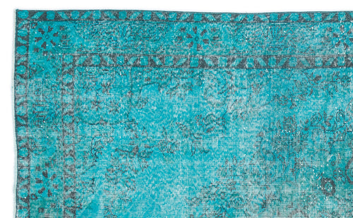 Load image 1 in gallery view. Bright turquoise rug with a distressed, dark grey floral medallion pattern and a decorative border.