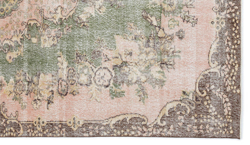 Load image 1 in gallery view. Distressed vintage-style rug with a floral medallion pattern in muted pink, sage green, and dark brown.