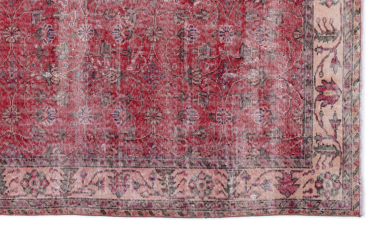 Distressed red and cream traditional rug with a faded floral medallion pattern and a decorative border.