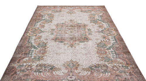 Load image 1 in gallery view. Distressed brown, cream, and sage green traditional rug with a central floral medallion and ornate border.