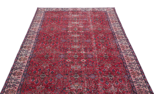 Load image 1 in gallery view. Red vintage-style rug with a distressed floral medallion pattern and a decorative border on a white background.
