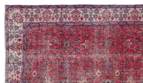 Load image 1 in gallery view. Distressed red rug with a floral medallion center and a pink and purple botanical border.