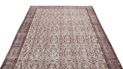Load image 1 in gallery view. Beige and brown vintage-style rug with a distressed floral medallion pattern and a wide decorative border.