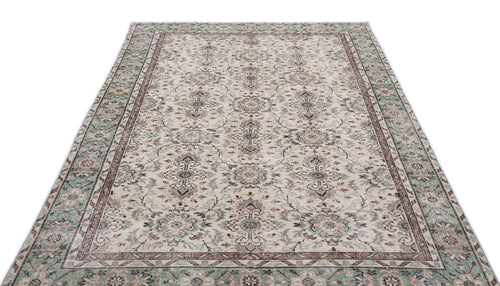 Load image 1 in gallery view. Cream, sage green, and mauve traditional rug with a distressed floral medallion pattern on a white background.