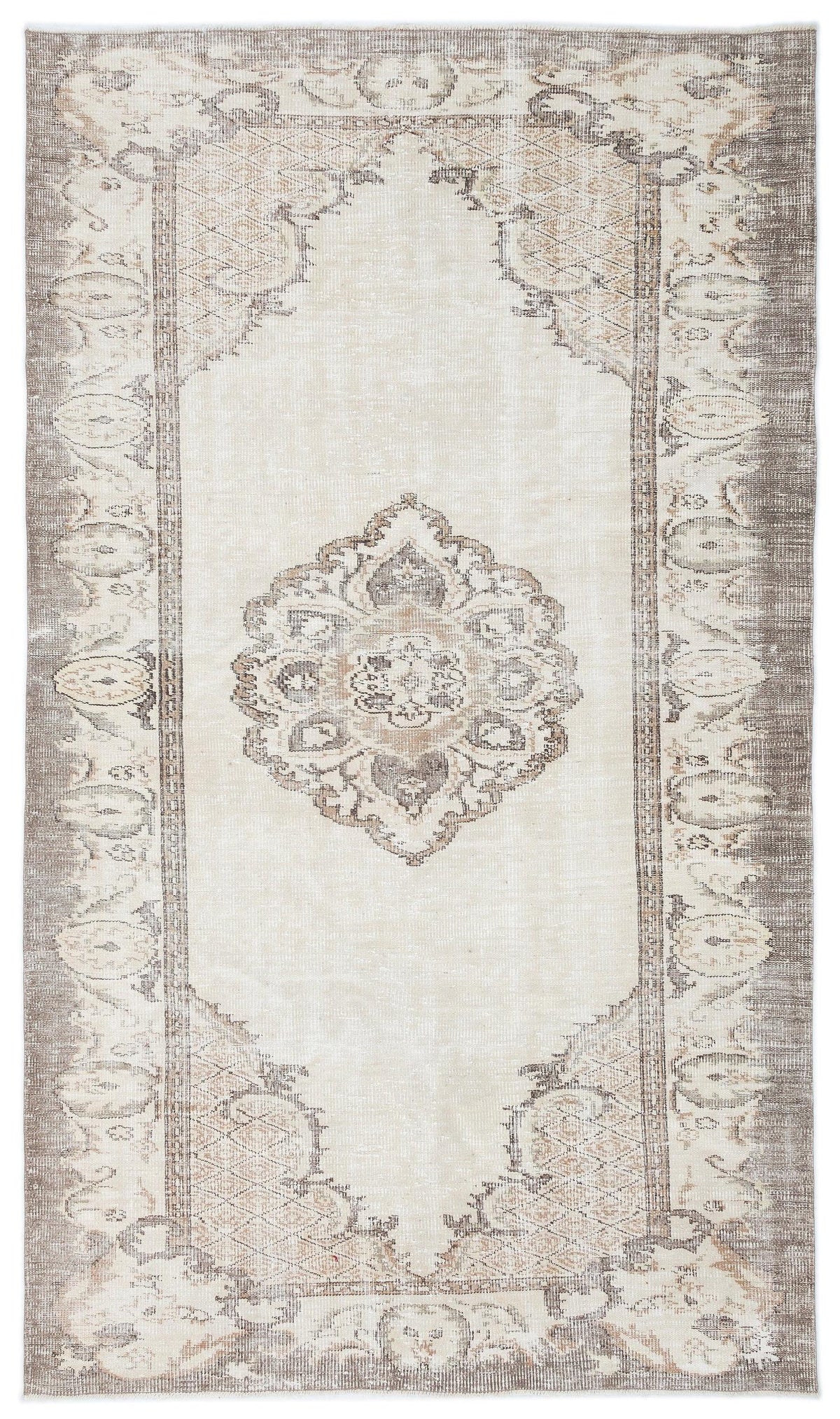 Cream and taupe distressed rug with a central floral medallion and ornate geometric border.