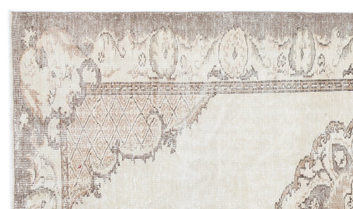 Load image 1 in gallery view. Distressed beige and taupe rug with a faded traditional medallion and geometric border pattern.